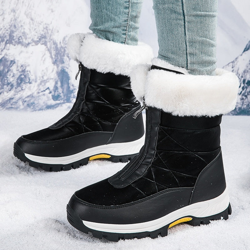 Black winter boots with white fur lining worn in the snow