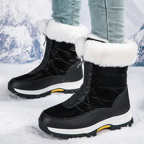 Black winter boots with white fur lining worn in the snow
